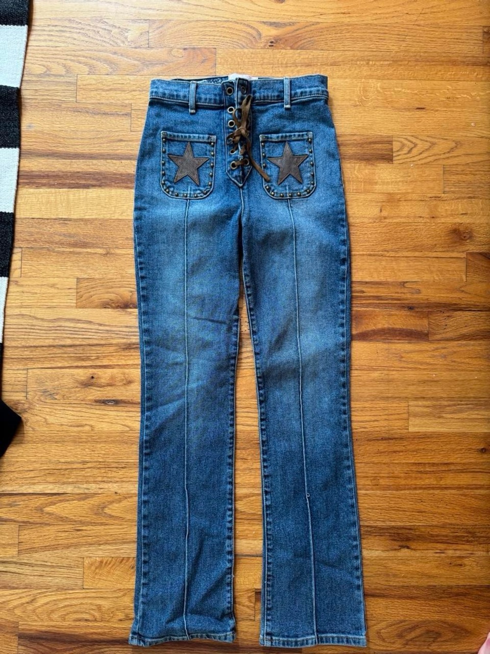 REVICE Lace-Up High-Rise Flare Jeans in Blue with Star Back Pockets
